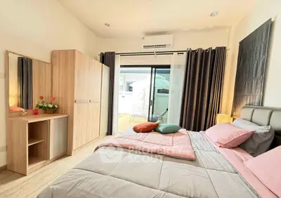 Spacious bedroom with modern decor and balcony access, featuring a cozy bed and ample storage.