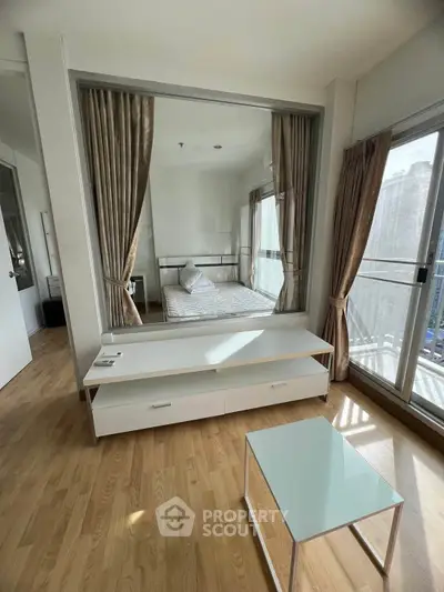 Modern studio apartment with glass partition and wooden flooring