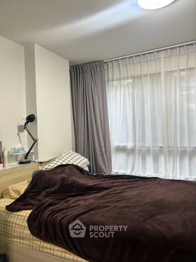 Cozy bedroom with large window and modern decor