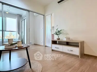 Modern living room with wooden flooring and stylish furniture in a bright apartment.