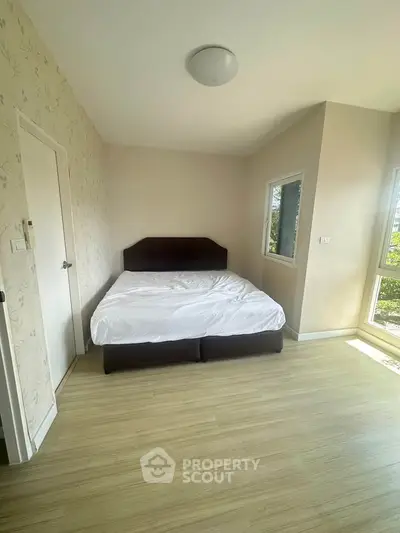 Spacious bedroom with natural light and modern decor