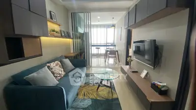 Modern living room with stylish decor and open layout to dining area.