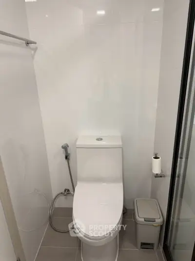 Modern bathroom with sleek white fixtures and minimalist design.