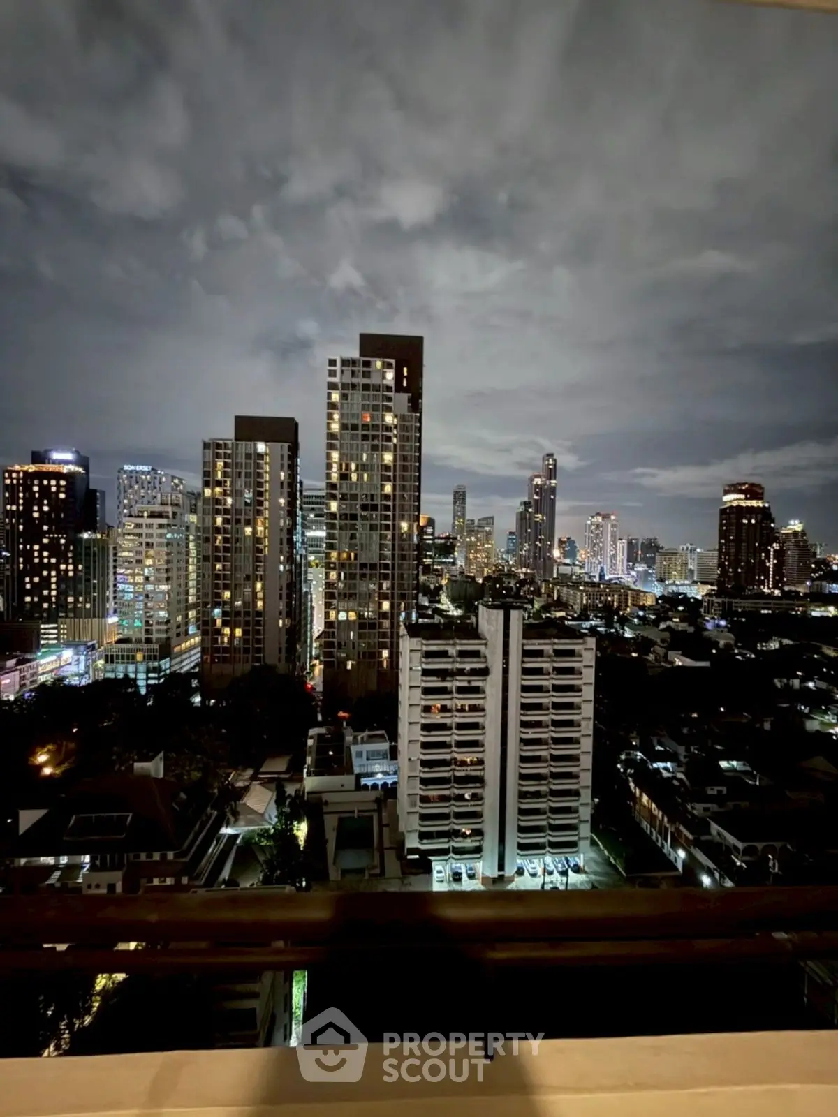 Stunning city skyline view from high-rise balcony at night