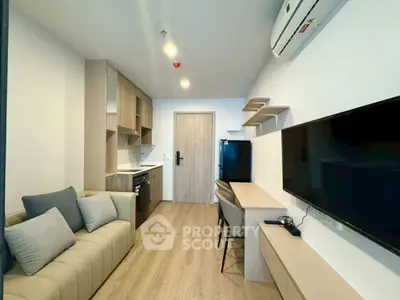 Modern living room with sleek furniture and integrated kitchen appliances in a cozy apartment.