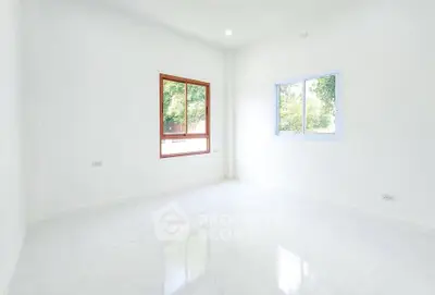Bright empty room with large windows and white walls, perfect for customization.