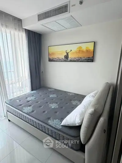 Modern bedroom with stylish decor and large window for natural light