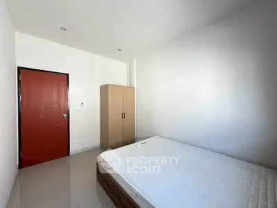 Minimalist bedroom with wardrobe and bed in modern apartment