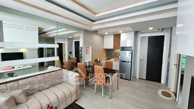 Modern open-layout living room and kitchen with sleek design and stylish furniture