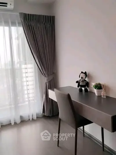 Modern study room with sleek desk and chair, large window with elegant curtains, and stylish decor.