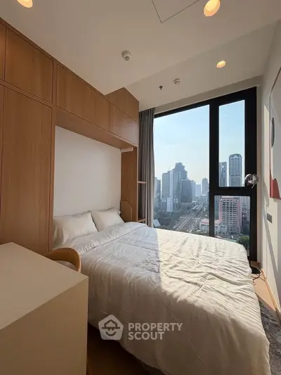 Modern bedroom with city view and natural light in high-rise apartment