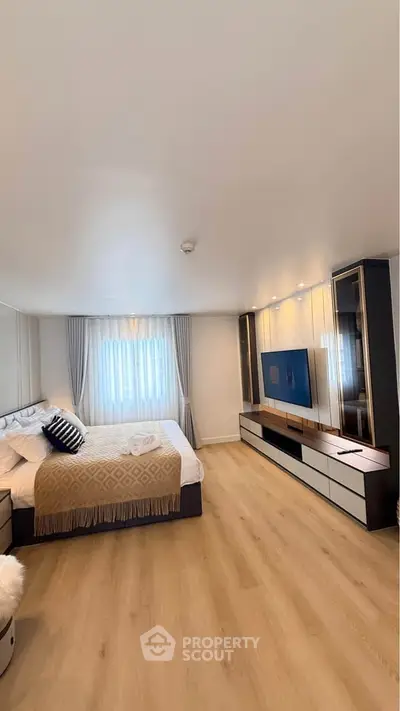 Spacious modern bedroom with elegant decor and natural light