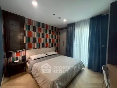 Modern bedroom with stylish decor and large window for natural light