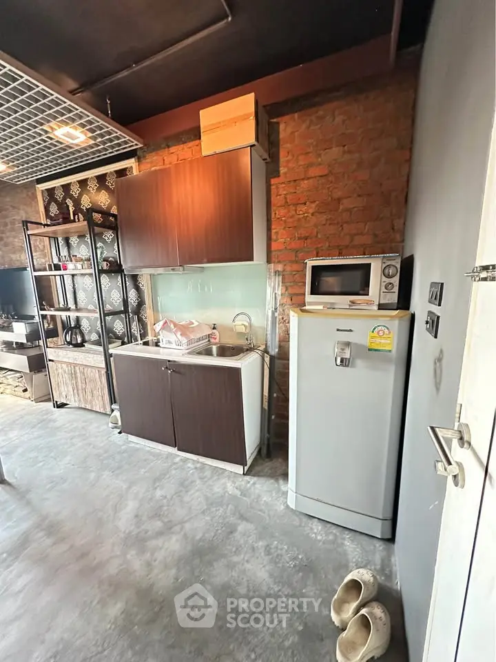 Modern industrial kitchen with exposed brick and sleek appliances