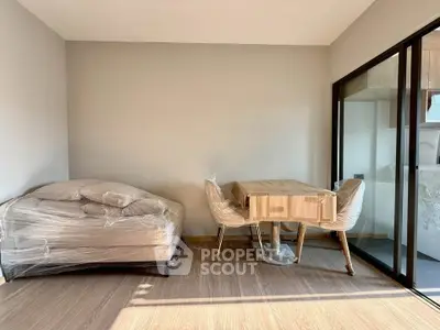 Modern living room with new furniture and large windows for natural light.