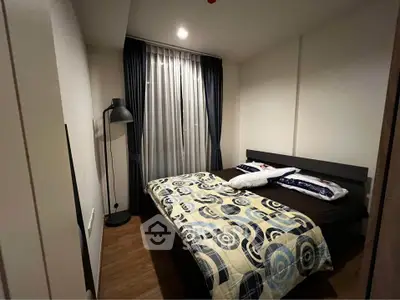 Cozy bedroom with modern decor and stylish lighting in a contemporary apartment.