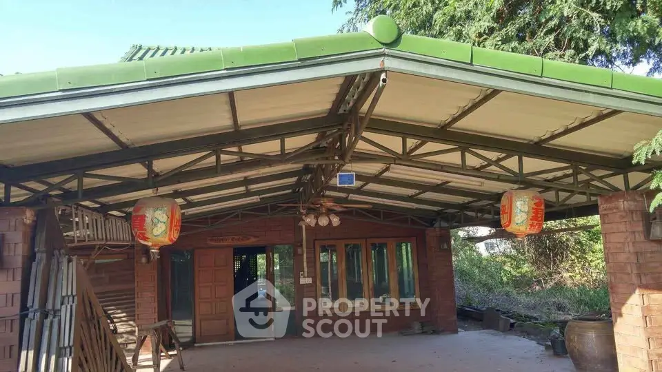 Charming rustic exterior with green roof and traditional lanterns, perfect for serene living.