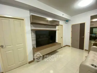Modern living room with sleek TV unit and neutral decor
