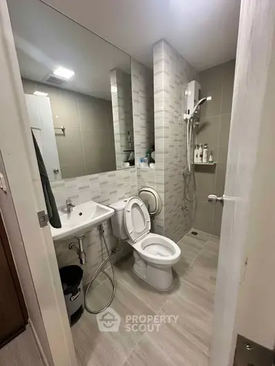 Modern bathroom with sleek design and shower area in contemporary apartment.