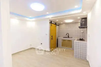Modern kitchen with sleek design and barn door in a bright interior space.