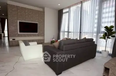 Spacious modern living room with large windows and elegant decor
