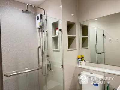 Modern bathroom with glass shower enclosure and sleek fixtures