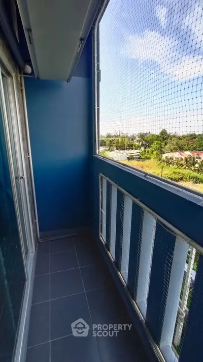 Charming balcony with safety netting and scenic view, perfect for relaxation.
