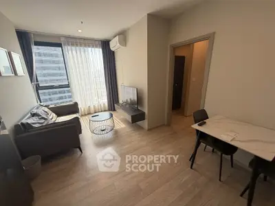 Modern living room with natural light, sleek furniture, and city view.