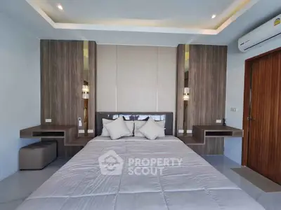 Modern bedroom with stylish wood paneling and cozy bedding in a contemporary home.