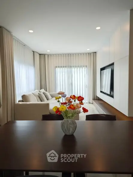 Elegant living room with modern decor and large windows for natural light