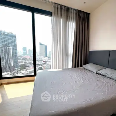 Modern bedroom with city view in high-rise apartment