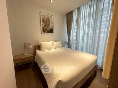 Cozy modern bedroom with large window and elegant decor