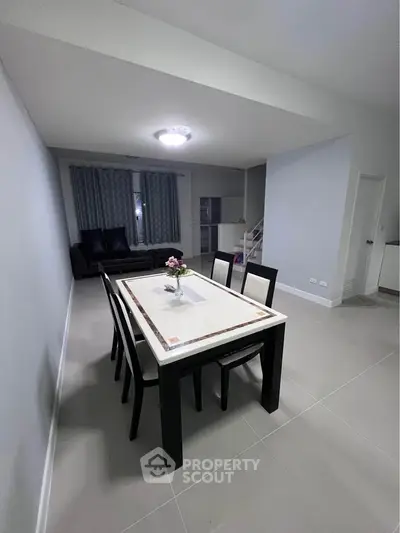Spacious dining area with modern decor and ample natural light, perfect for family gatherings.