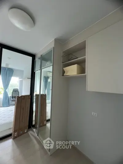Modern bedroom with mirrored wardrobe and large windows for natural light