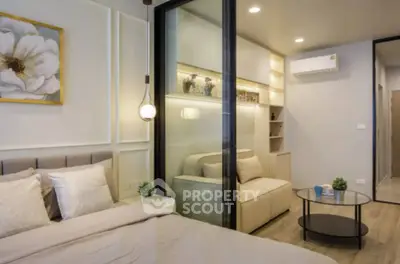 Modern bedroom with elegant decor and cozy seating area, featuring stylish lighting and contemporary design.