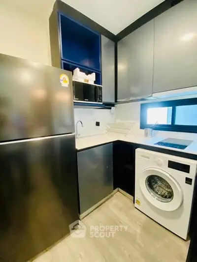 Modern compact kitchen with sleek appliances and ample storage space