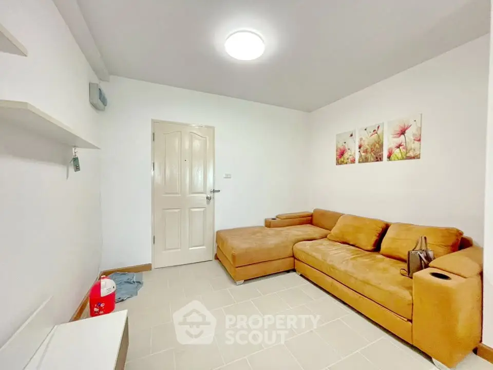 Cozy living room with modern decor and comfortable seating in a stylish apartment.