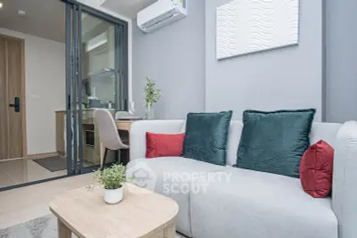 Modern living room with stylish decor and open kitchen layout in a cozy apartment.