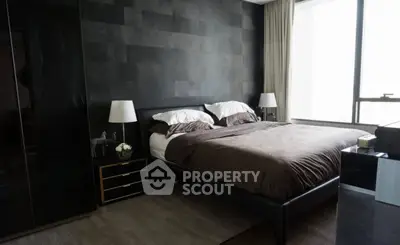 Luxurious modern bedroom with sleek black accents and large window view.