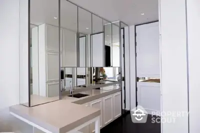 Modern kitchen with sleek mirrored cabinets and minimalist design