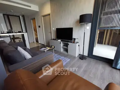 Modern living room with sleek furniture and open kitchen layout