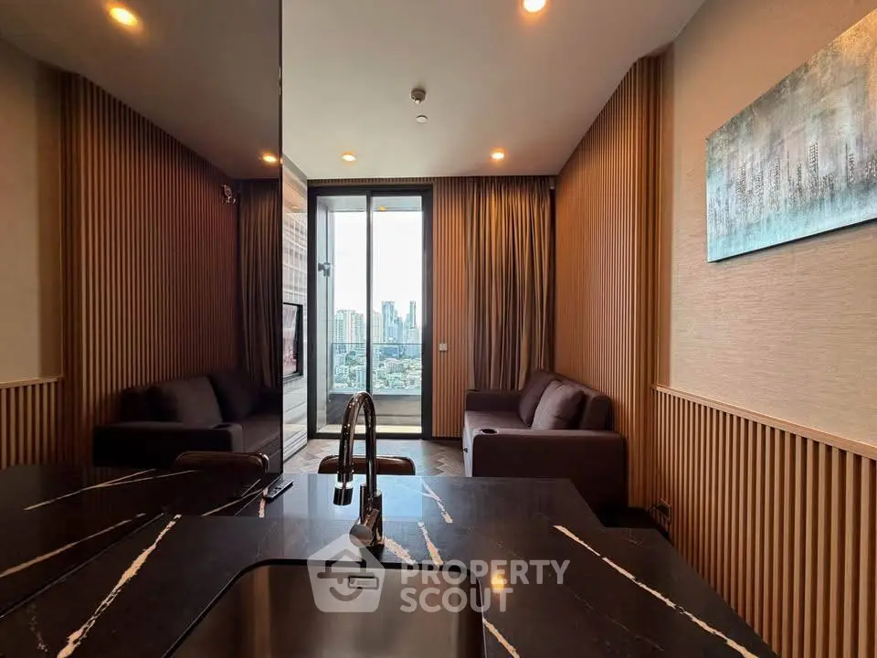 Modern living room with city view, featuring sleek design and elegant furnishings.