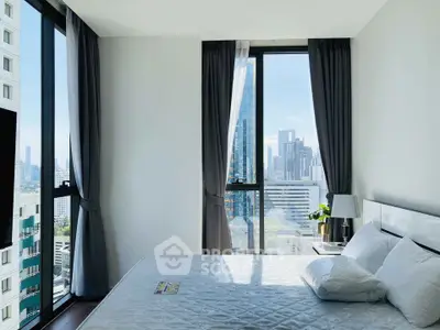 Modern bedroom with city view and large windows in high-rise apartment