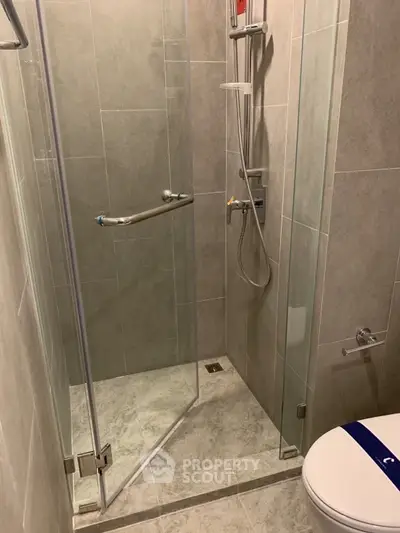 Modern bathroom with glass shower enclosure and sleek tile design