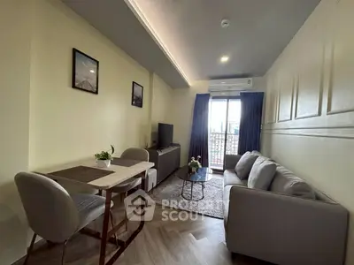 Modern living room with cozy sofa, dining table, and natural light from balcony.
