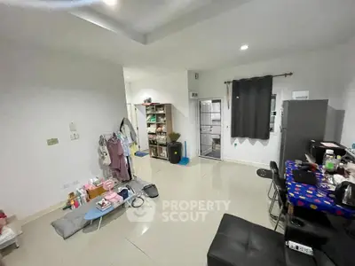 Spacious living area with modern furnishings and tiled flooring, perfect for comfortable living.