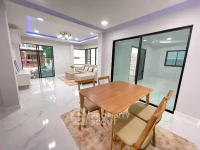Modern open-plan living and dining area with sleek design and natural light.