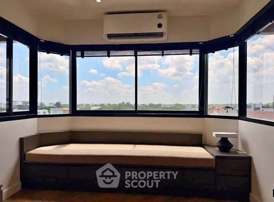 Spacious corner unit with panoramic windows and cozy seating area.