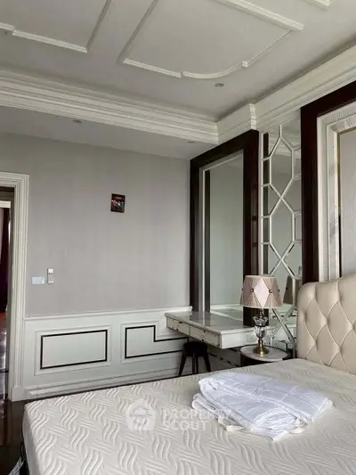 Luxurious bedroom with elegant decor and plush bedding in a sophisticated real estate property.