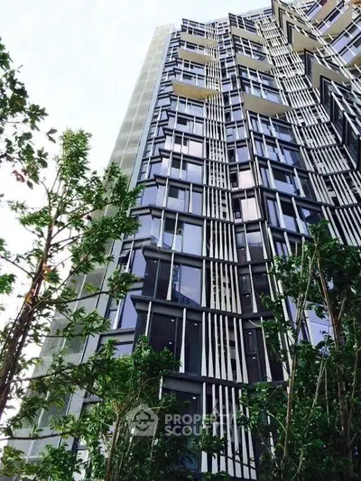 Modern architectural building with unique facade design and lush greenery